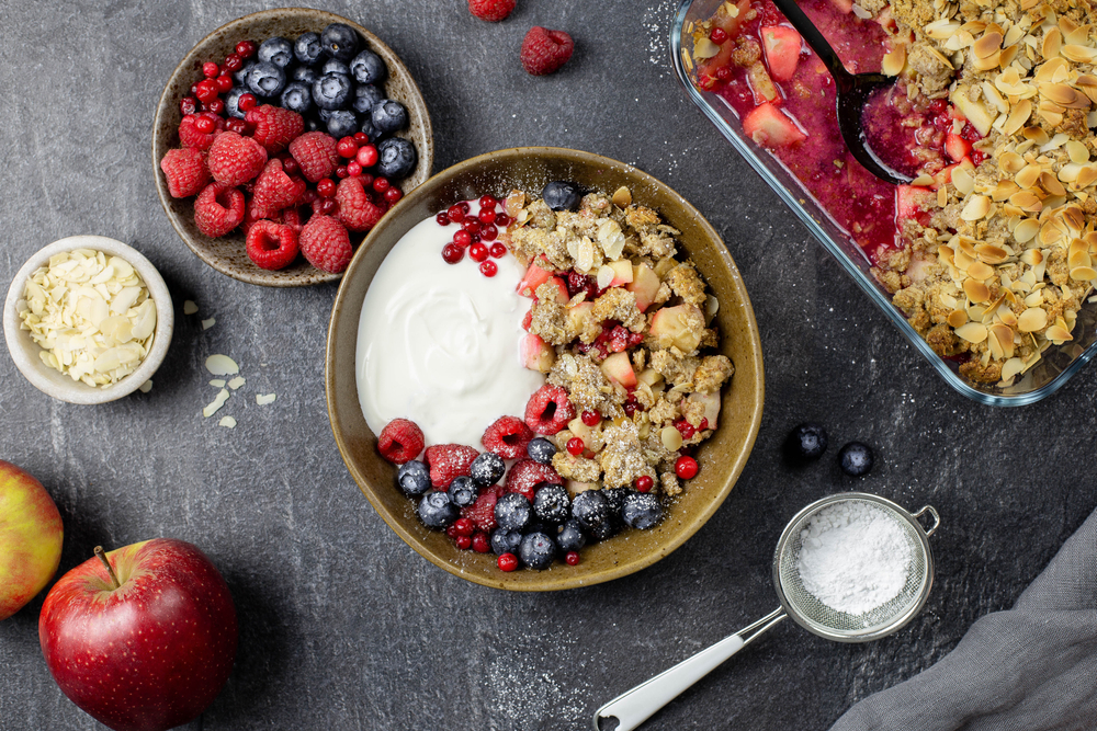 bowl, of, yogurt, with, granola, and, berries, with, apples, and, snacks
