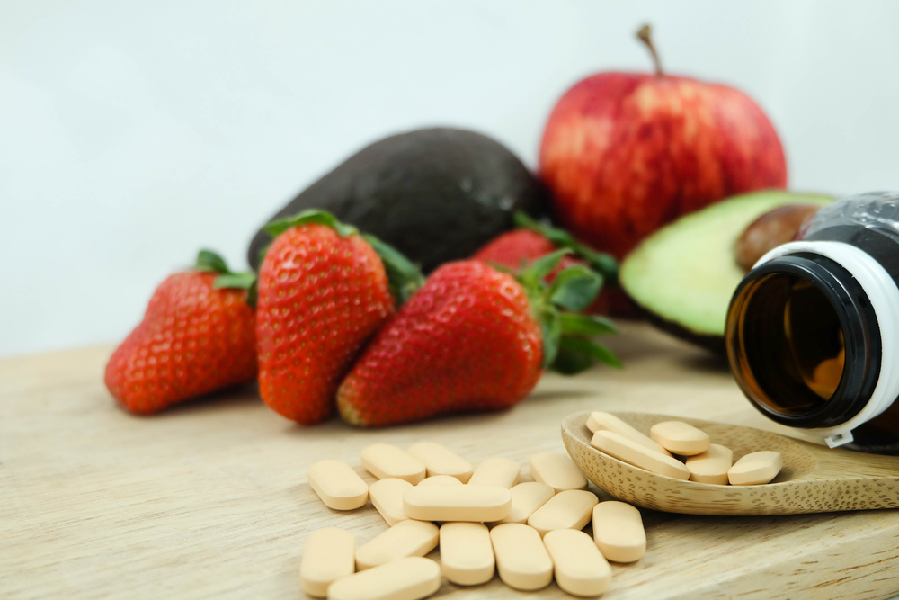 supplements, on, table, with, fruit, surrounding, it
